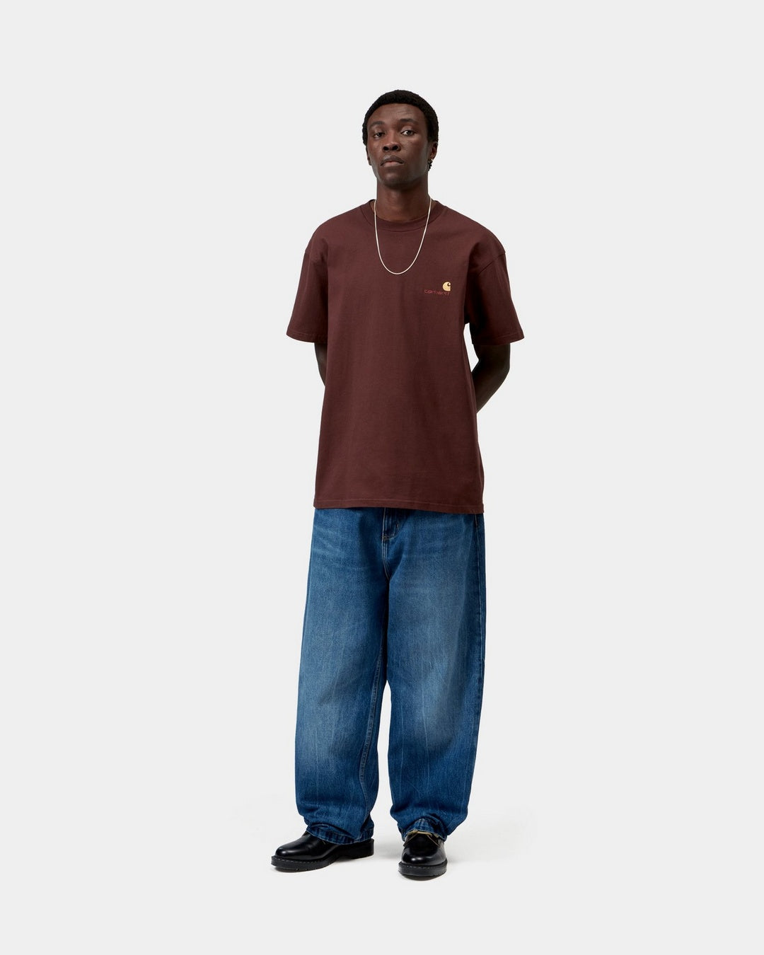 Carhartt WIP S/S American Script T-Shirt in Amarone, worn by model, front view with small chest logo embroidery.