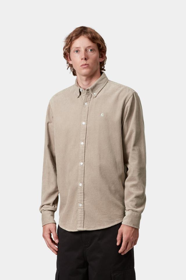 Man wearing a beige button-up shirt against a white background
