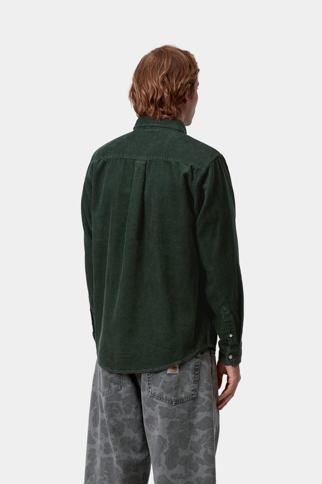 Person wearing a green shirt and gray pants on a white background