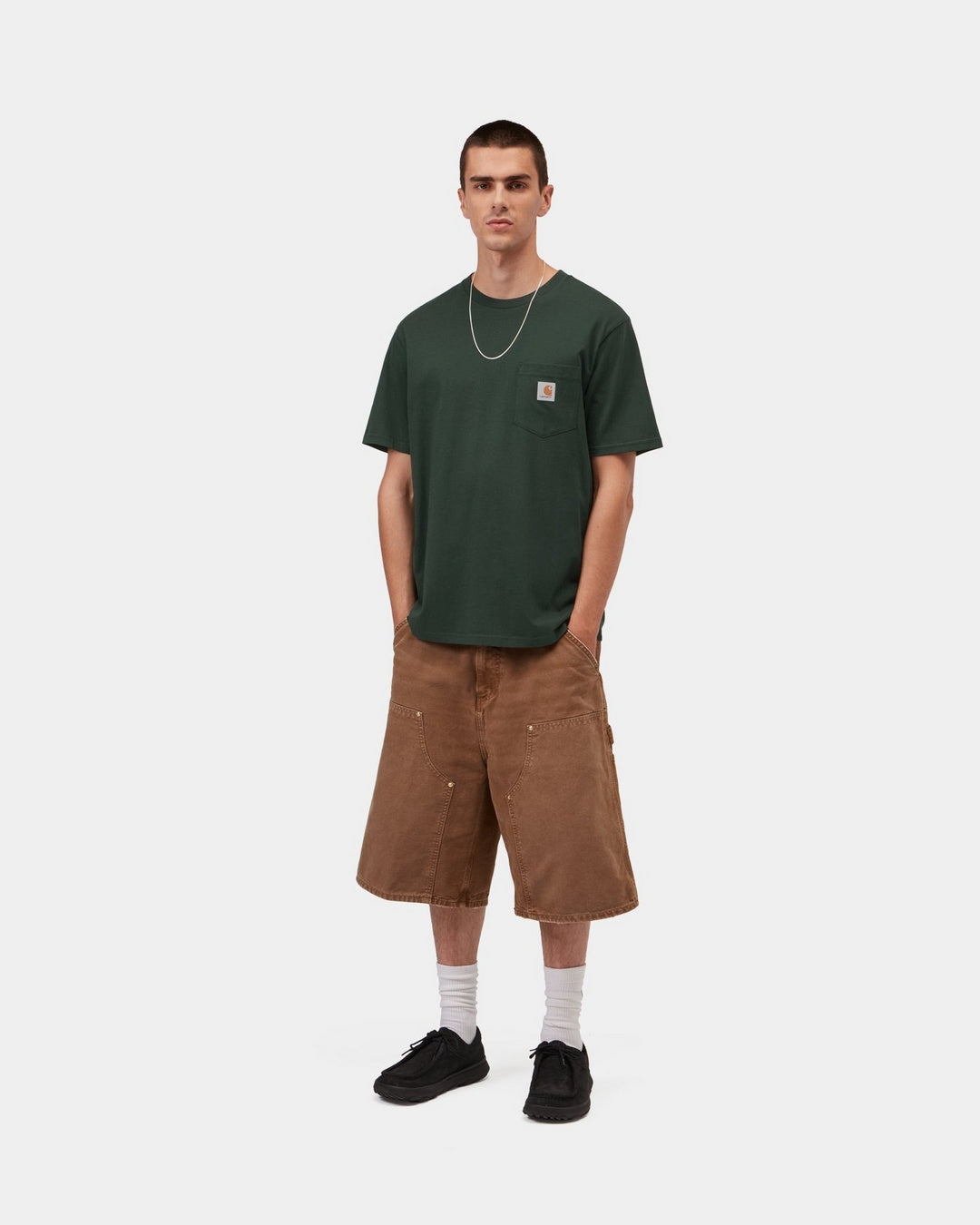 Carhartt WIP S/S Pocket T-Shirt in Dark Scarab, front view on model with chest pocket and logo label visible