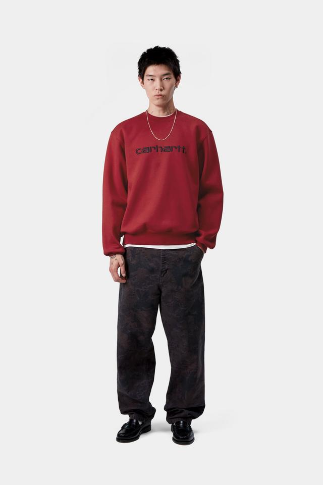 Person wearing a red sweatshirt with text on a white background