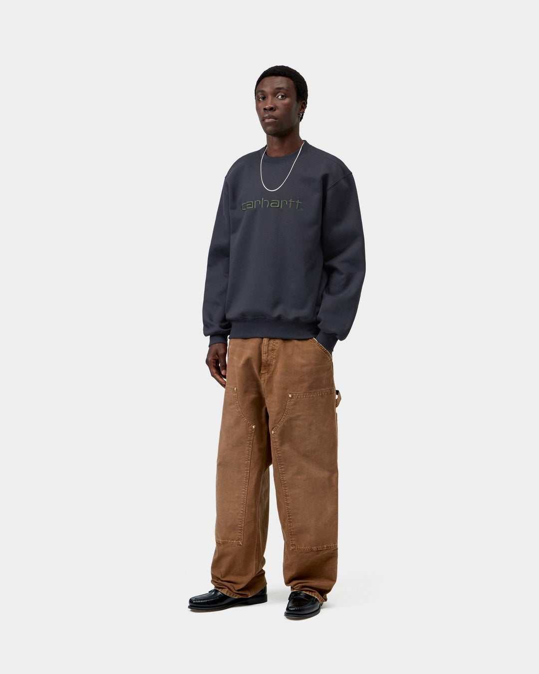 Carhartt WIP Carhartt Sweatshirt in Dark Navy / Dark Scarab, front view, with embroidered chest logo, shown on model.