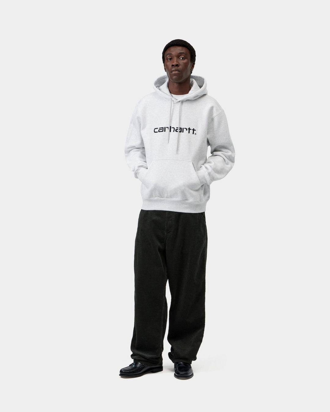 Carhartt WIP Hooded Carhartt Sweatshirt in Ash Heather / Graphite, shown on model with hood up, front view, kangaroo pocket and chest logo visible.