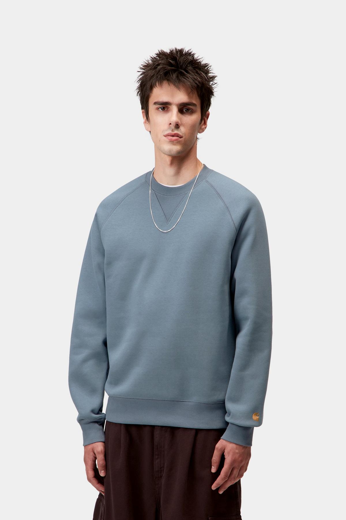 Man wearing a light blue sweatshirt on a white background