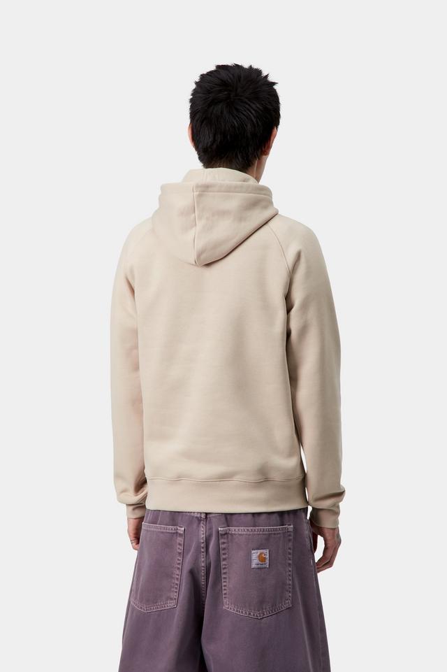 Person wearing a beige hoodie and purple pants on a white background