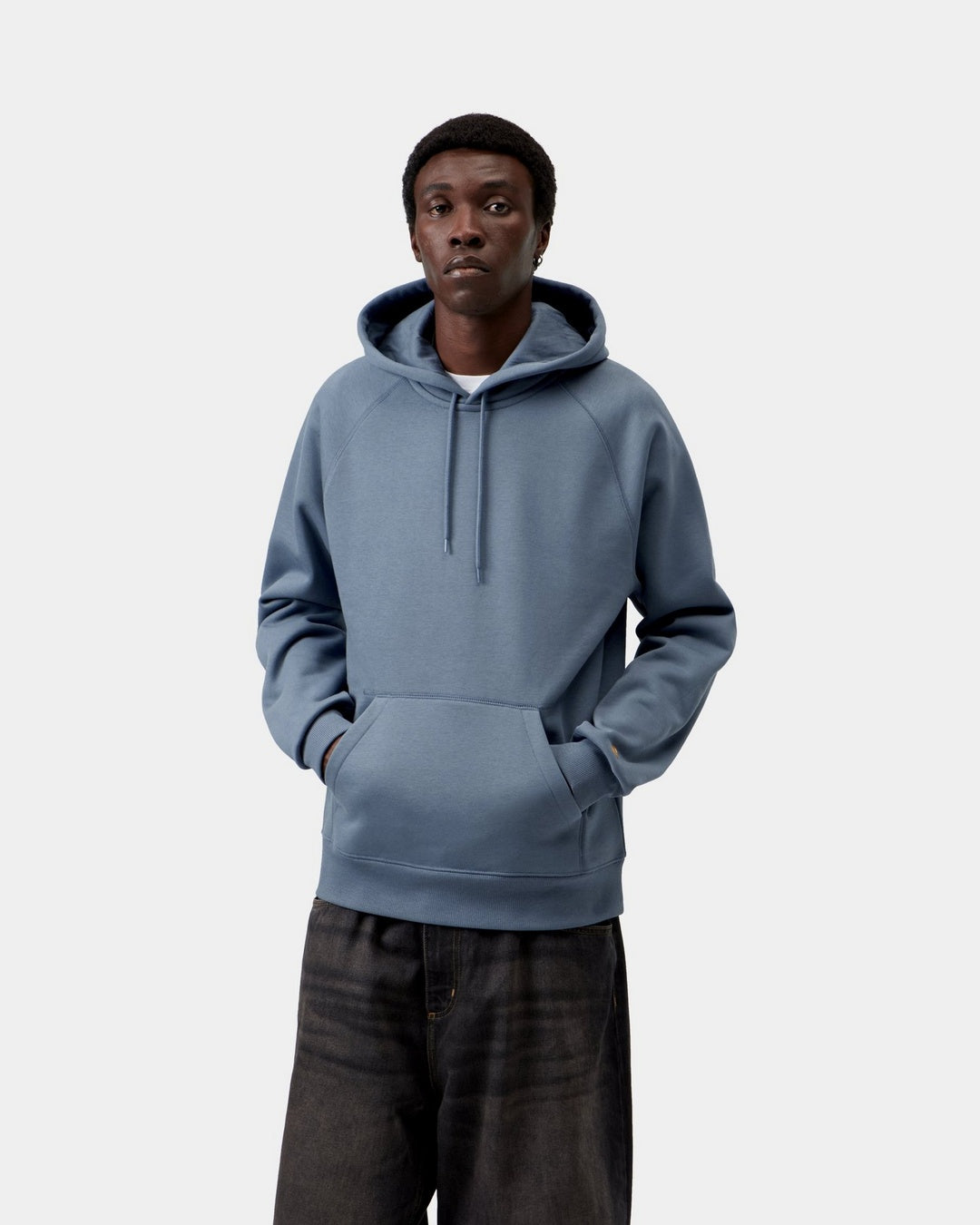 Carhartt WIP Hooded Chase Sweatshirt in Icesheet / Gold, front view, worn by model with hood up and kangaroo pocket.