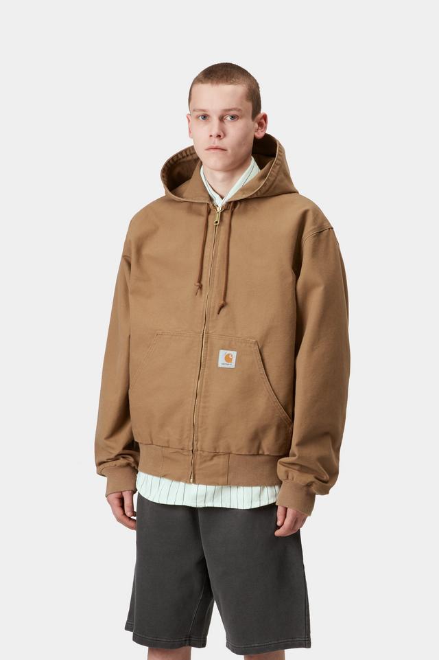 Person wearing a brown hooded jacket on a white background