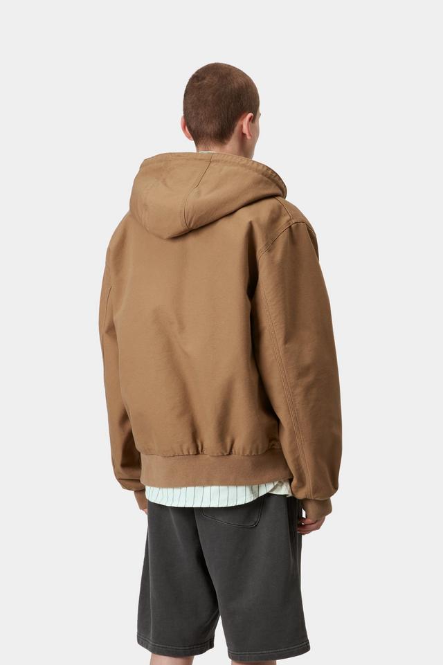 Person wearing a brown hooded jacket on a white background