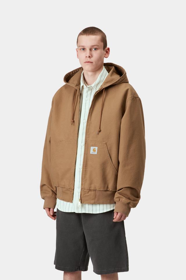 Person wearing a brown hooded jacket on a white background