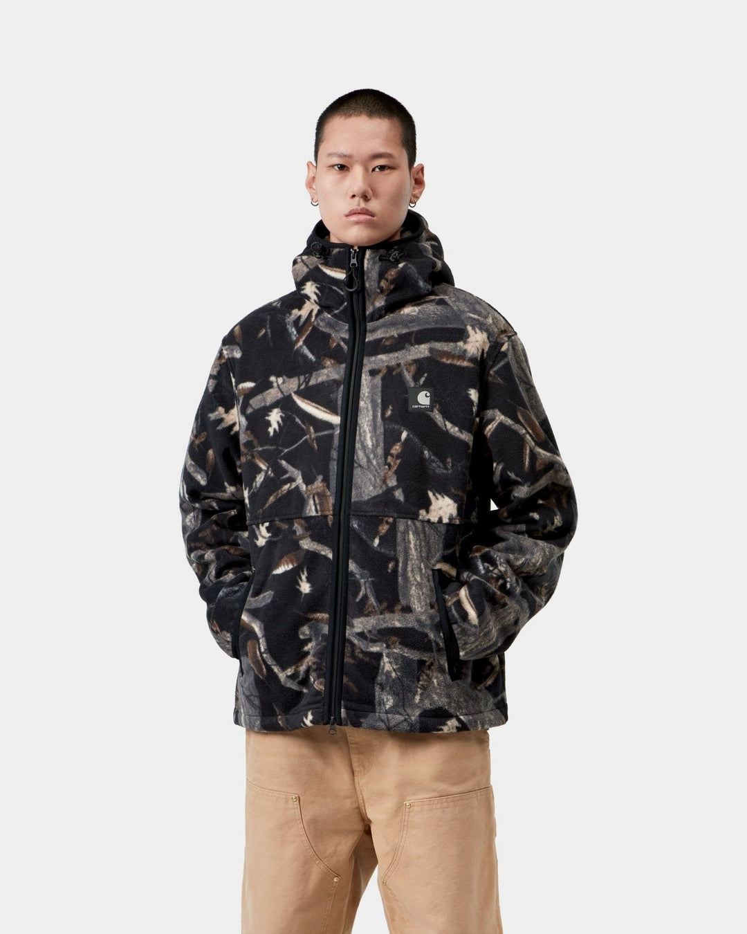 Carhartt WIP Blevin Liner in Camo Feather Tree, Black, shown front view with full zip, hood, and chest logo patch, shown on model.