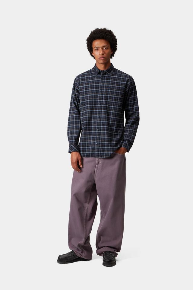 Person wearing a plaid shirt and purple pants on a white background