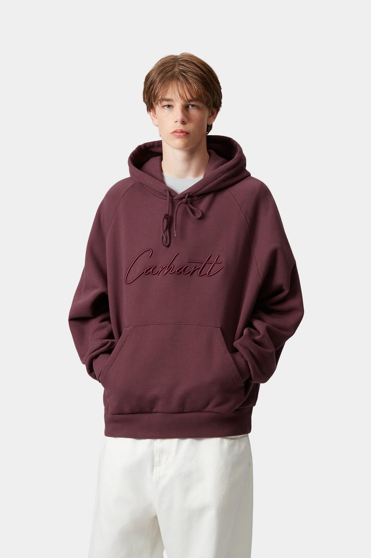 Person wearing a maroon hoodie with text on a white background