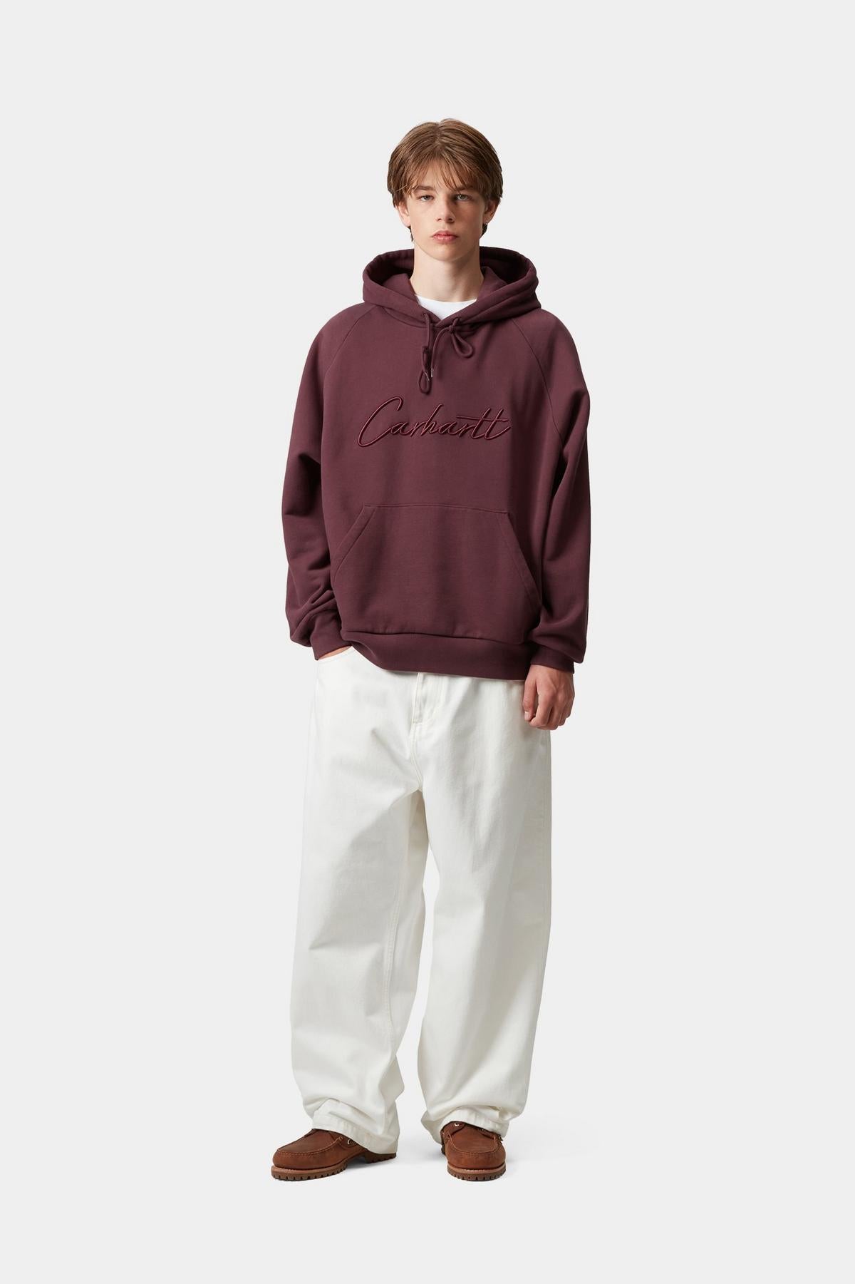Person wearing a maroon hoodie with text on a white background