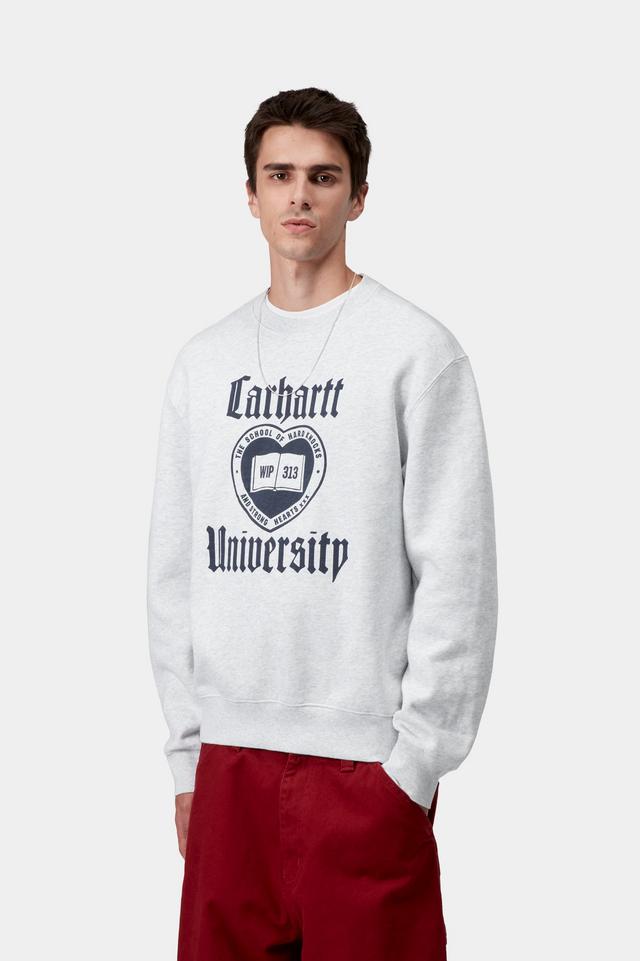 Person wearing a white Carhartt sweatshirt with a logo and text on a white background