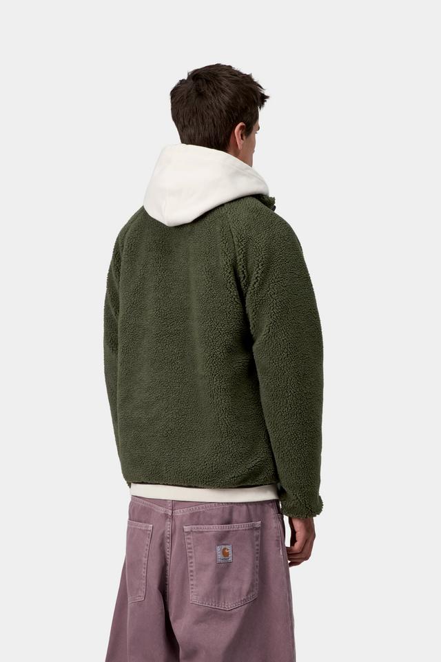 Person wearing a green fleece jacket with a white hood on a light gray background