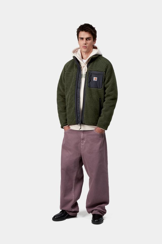 Man wearing a green fleece jacket and purple pants on a white background