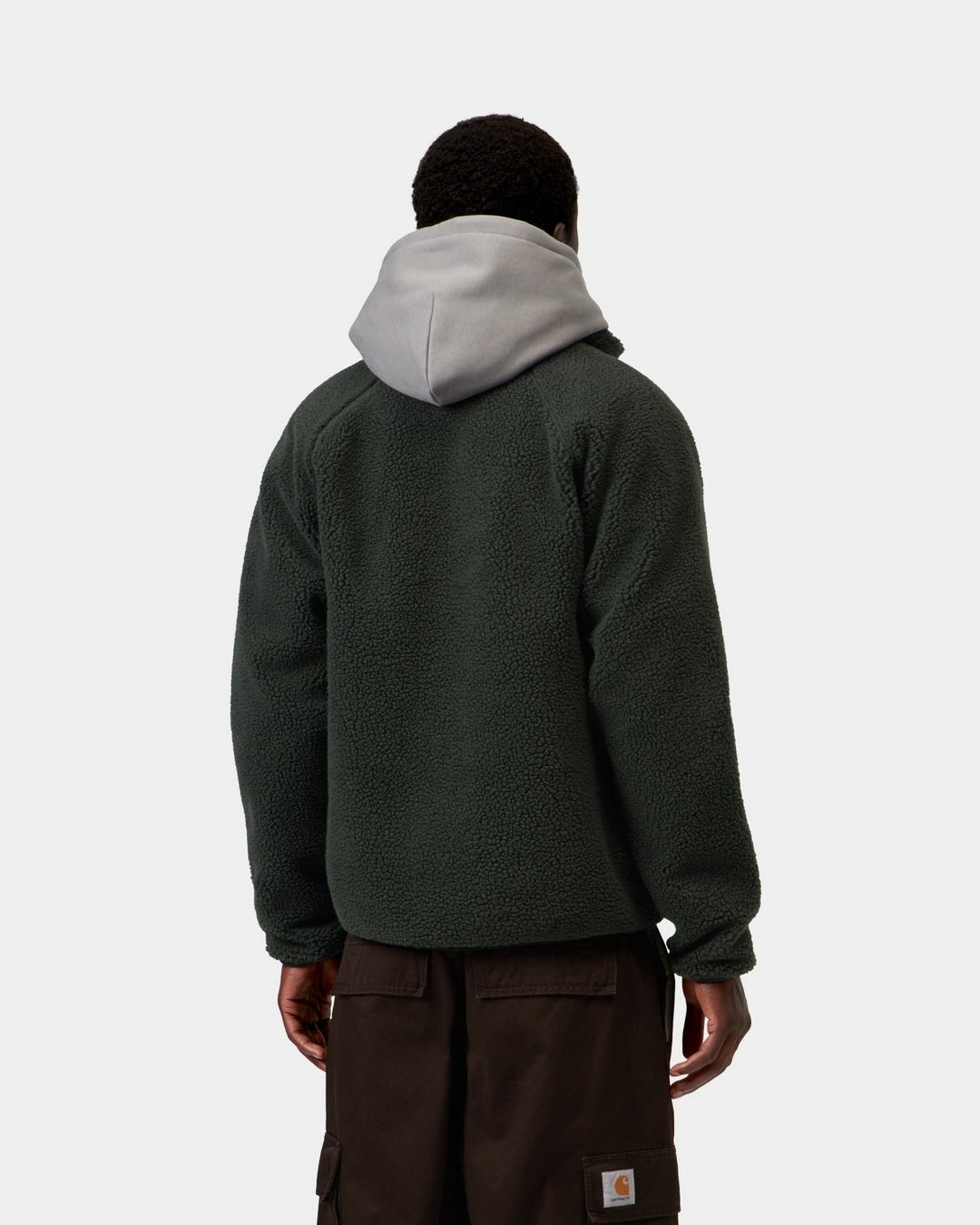 Back view of a Carhartt WIP Prentis Liner in Raven / Black, showing the textured fleece body and light grey hood, shown on model.
