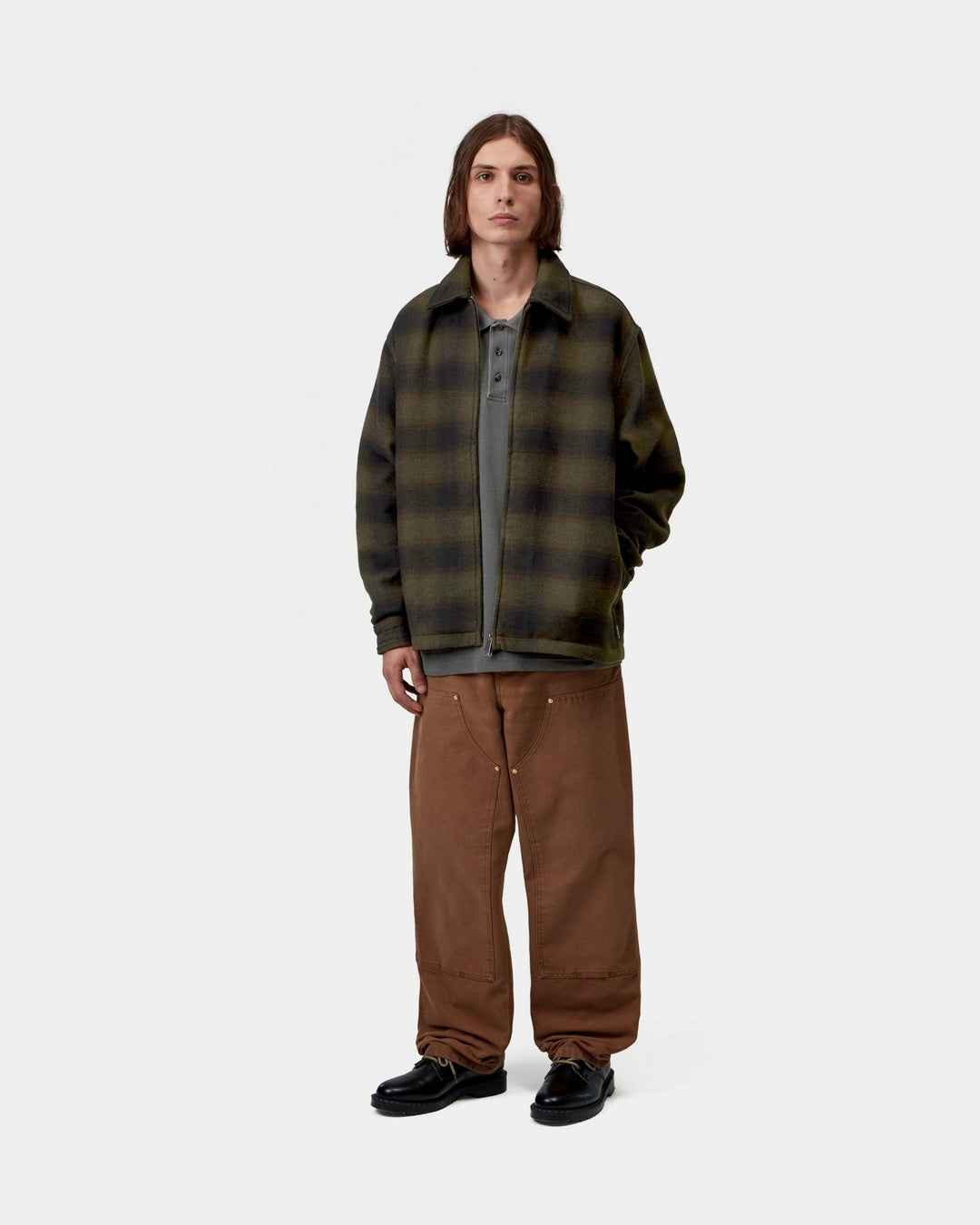 Carhartt WIP Alton Jacket in Alton Check, Cypress worn open by a model, front view, showing the allover check pattern, pointed collar, zip front, and side pockets.