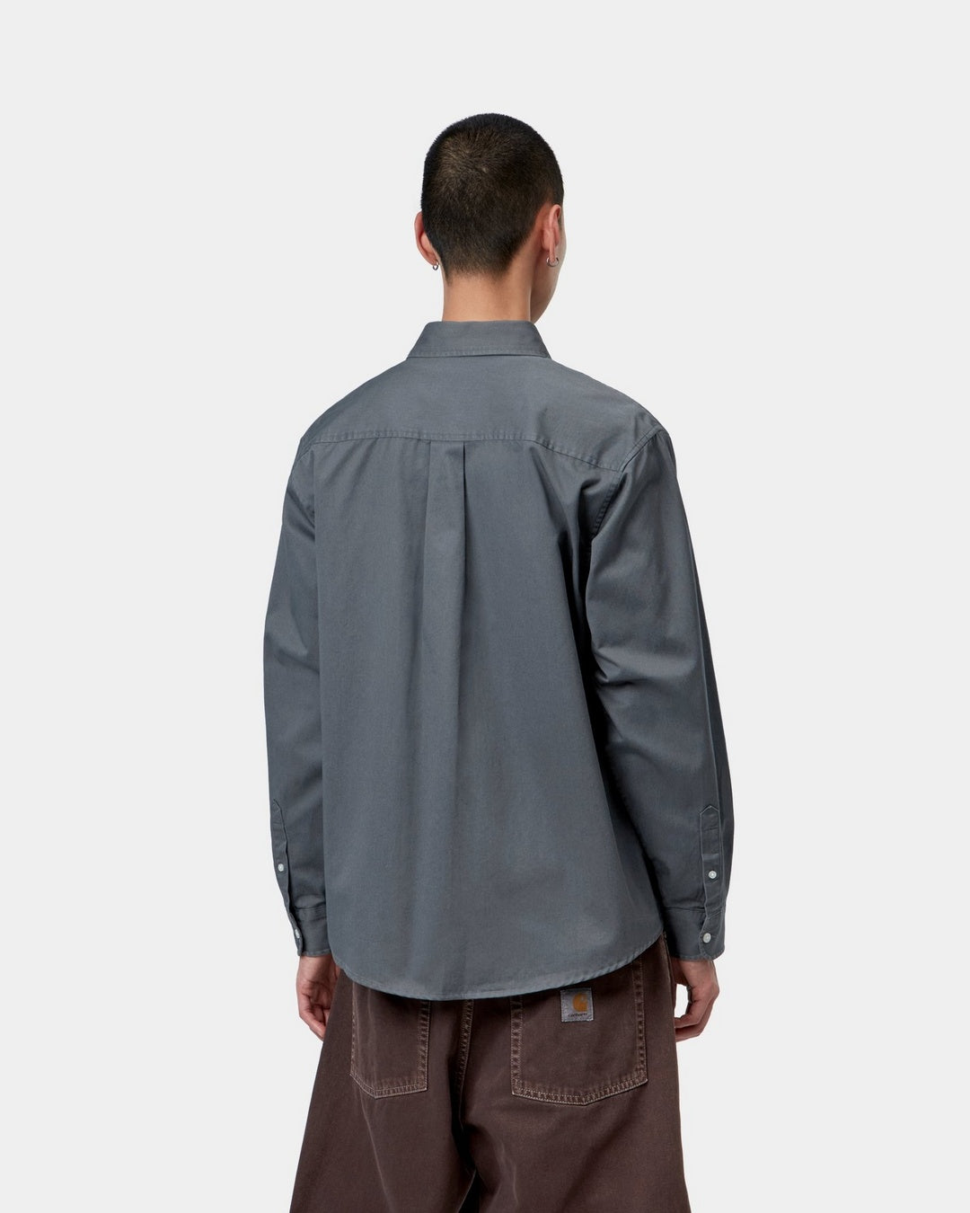 Carhartt WIP L/S OG Madison Shirt in Styx, back view, showing a loose-fit long-sleeve button-up shirt with a button-down collar and curved hem, shown on model.