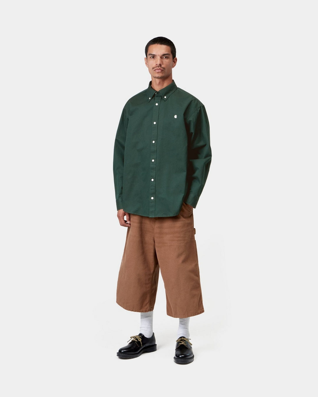 Carhartt WIP L/S OG Madison Shirt in Dark Scarab, shown worn on model with button-down collar, front button closure and chest logo.