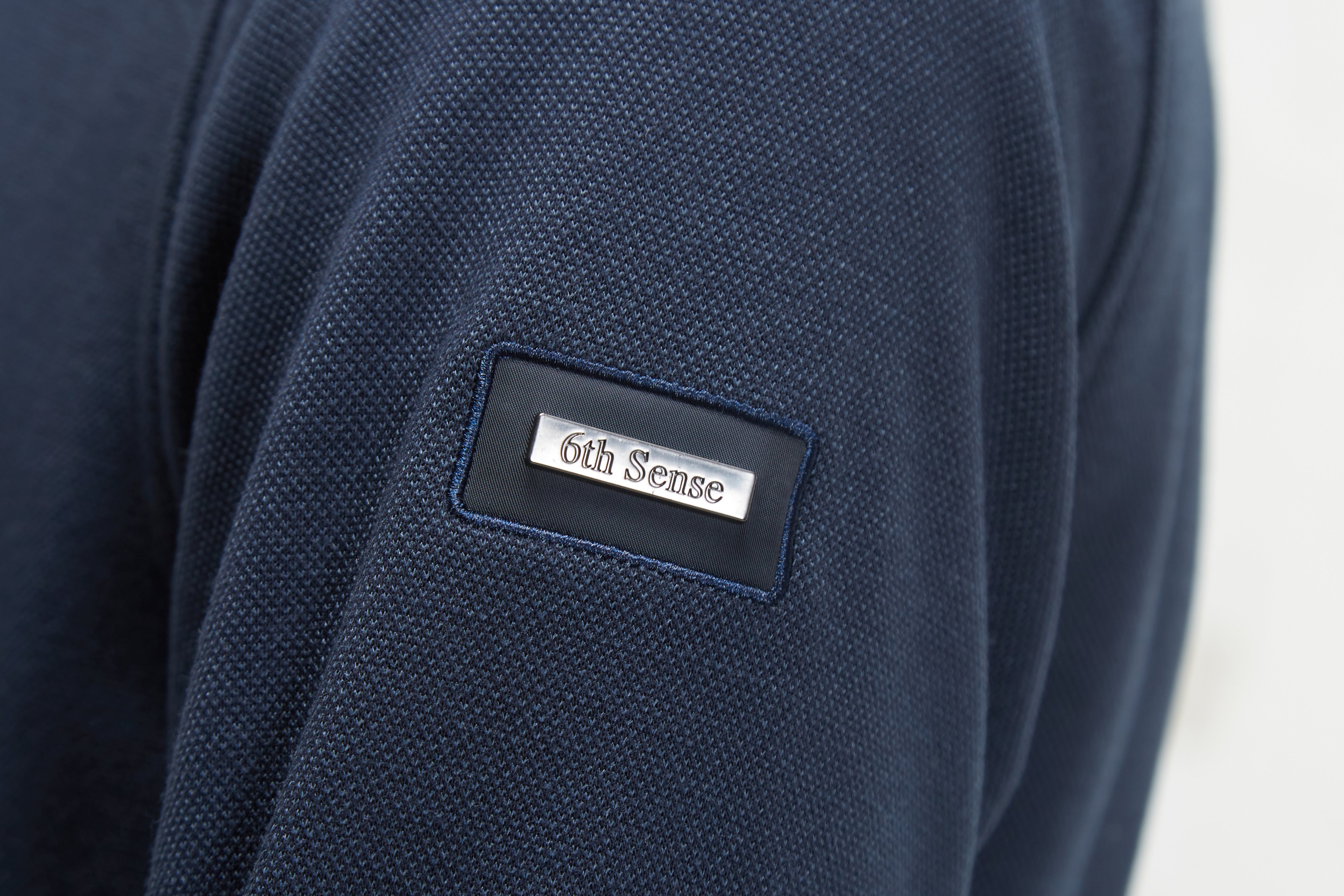 Navy blue fabric with '6th Sense' label on a white background