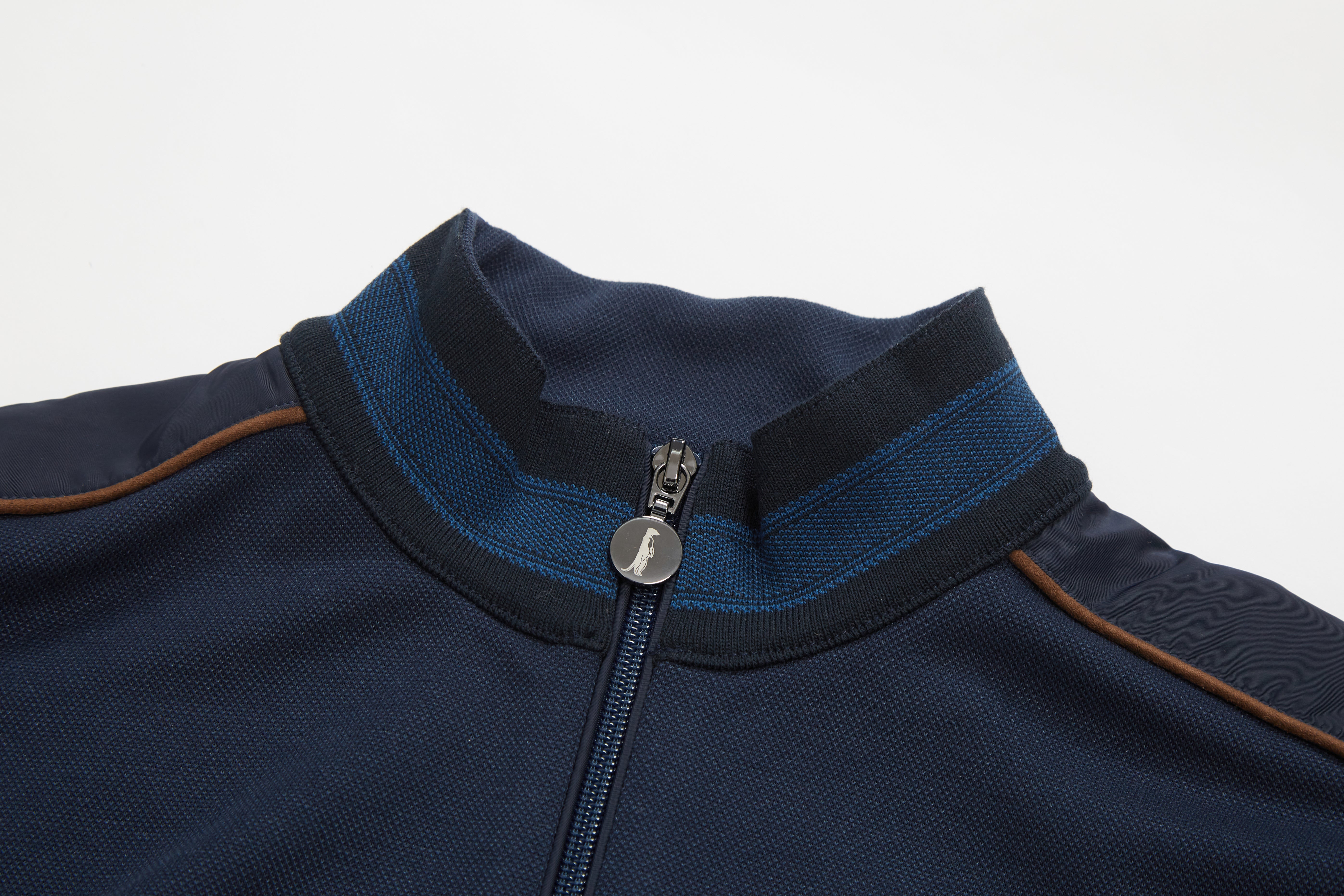 Close-up of a navy blue jacket with a zipper on a light gray background