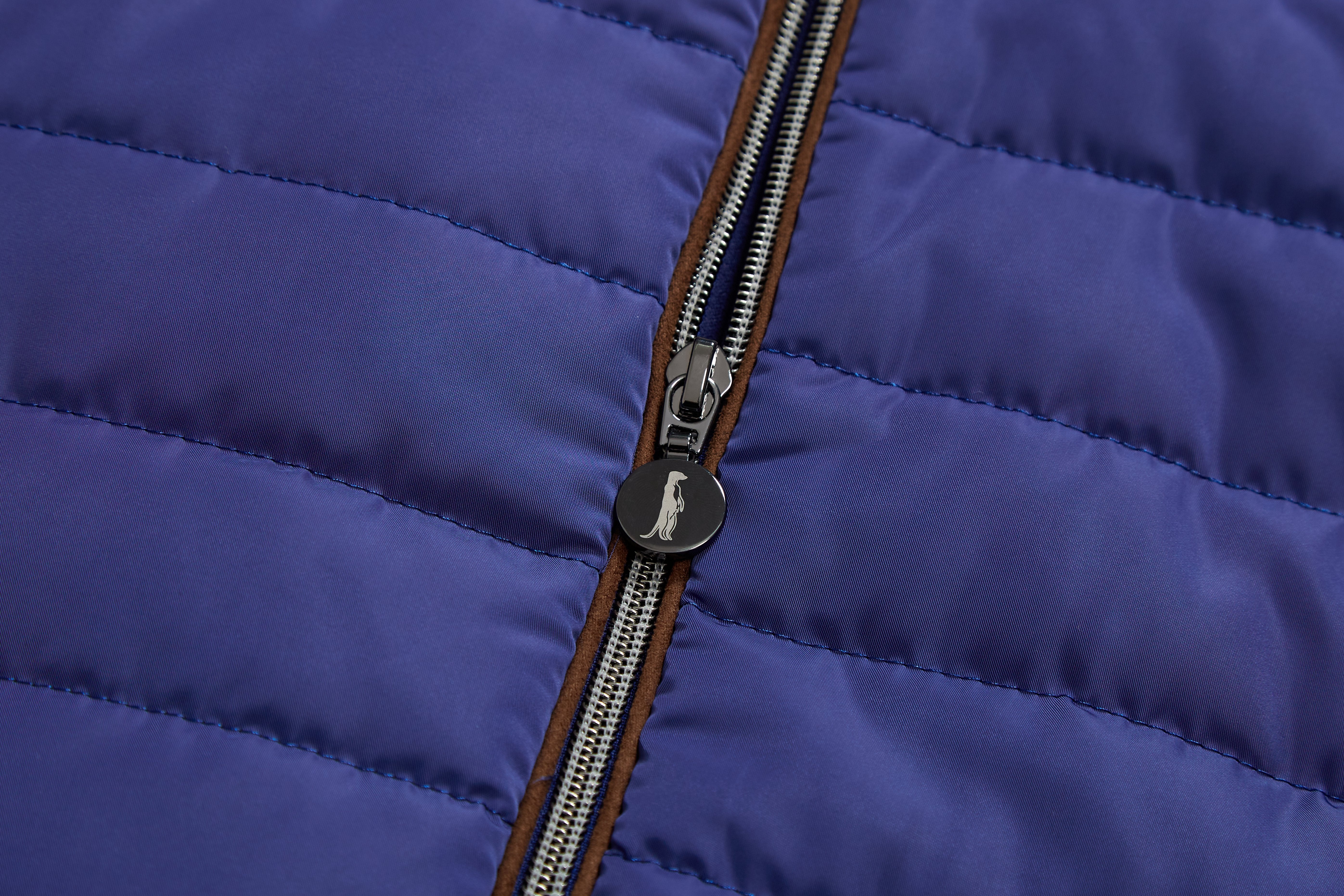 Close-up of a blue puffer jacket with a zipper