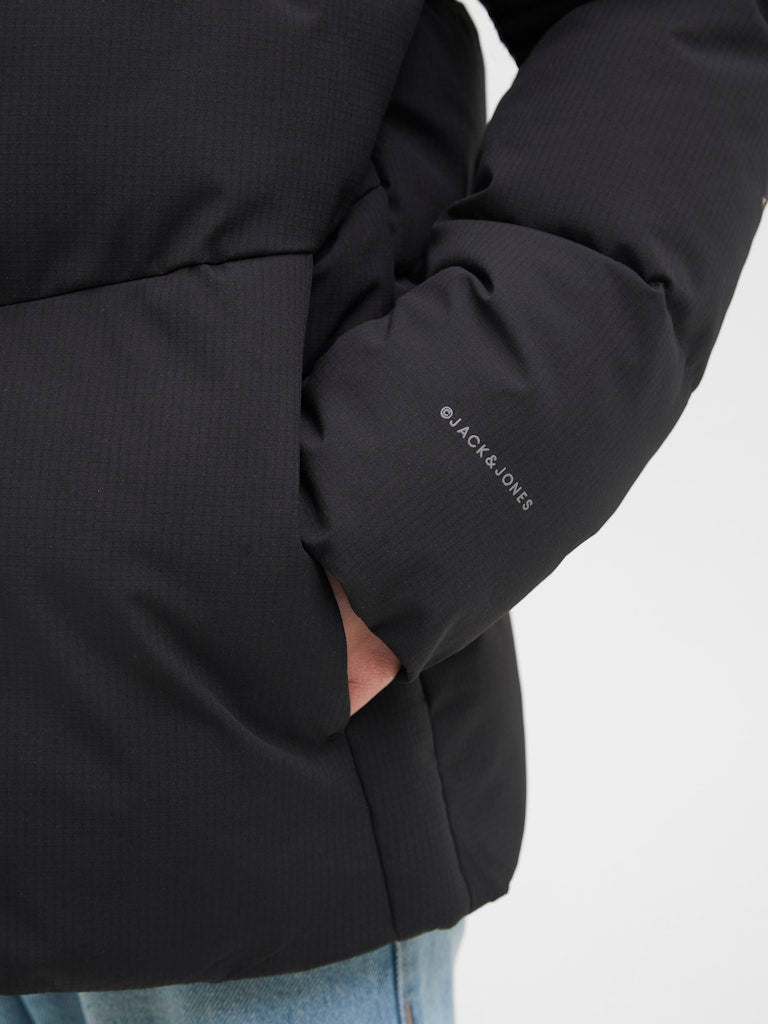 Black jacket with 'Jack & Jones' branding on a white background