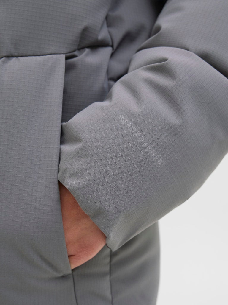 Close-up of a gray jacket with 'Jack Jones' branding on a light gray background
