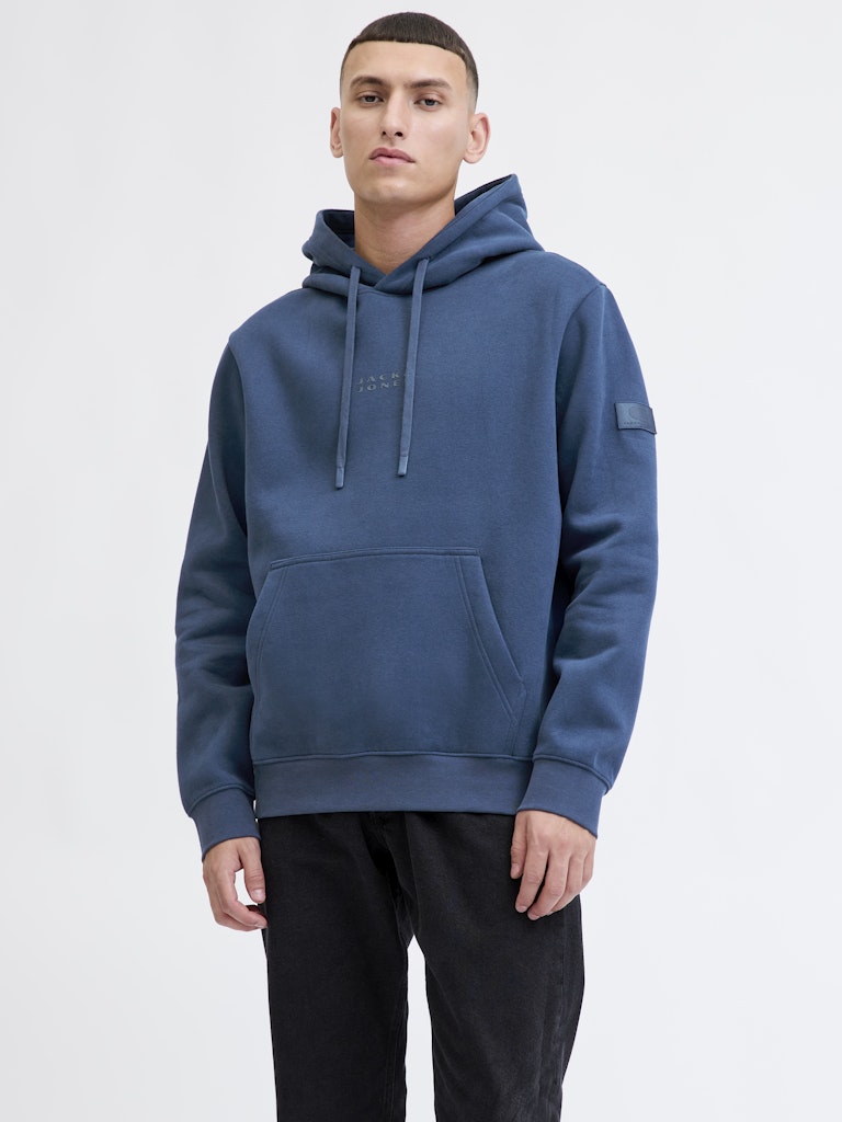 Person wearing a blue hoodie on a white background