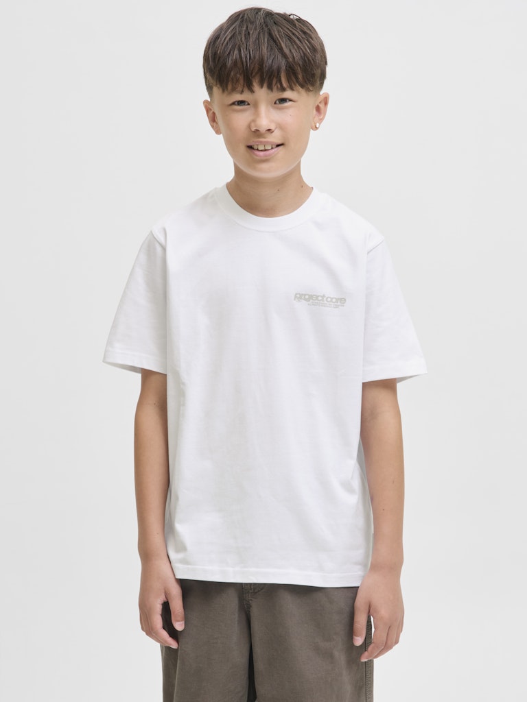 Child wearing a white t-shirt with a logo on a plain background