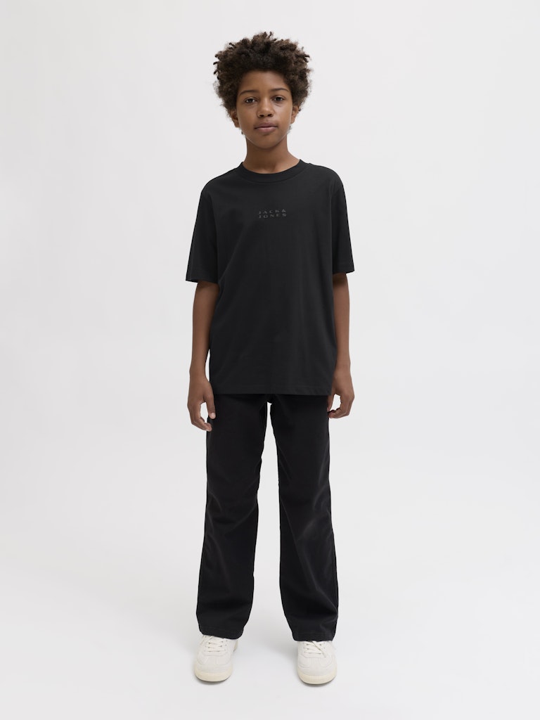 Person wearing a black t-shirt and pants on a white background