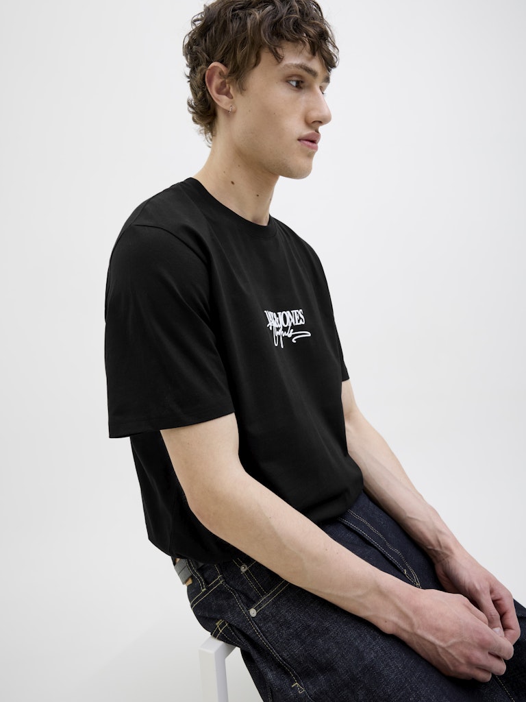 Almeria Branding Black Tee-Model sitting down view