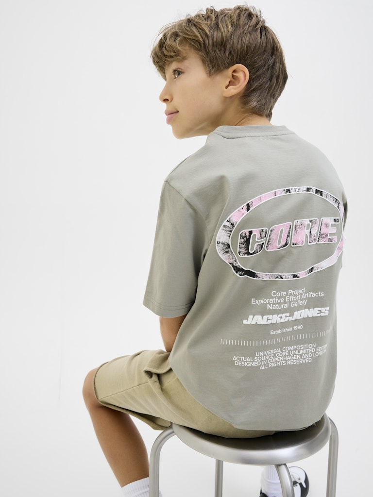 Lido Back Print Boys Shadow Grey Tee-Model sitting on stool
