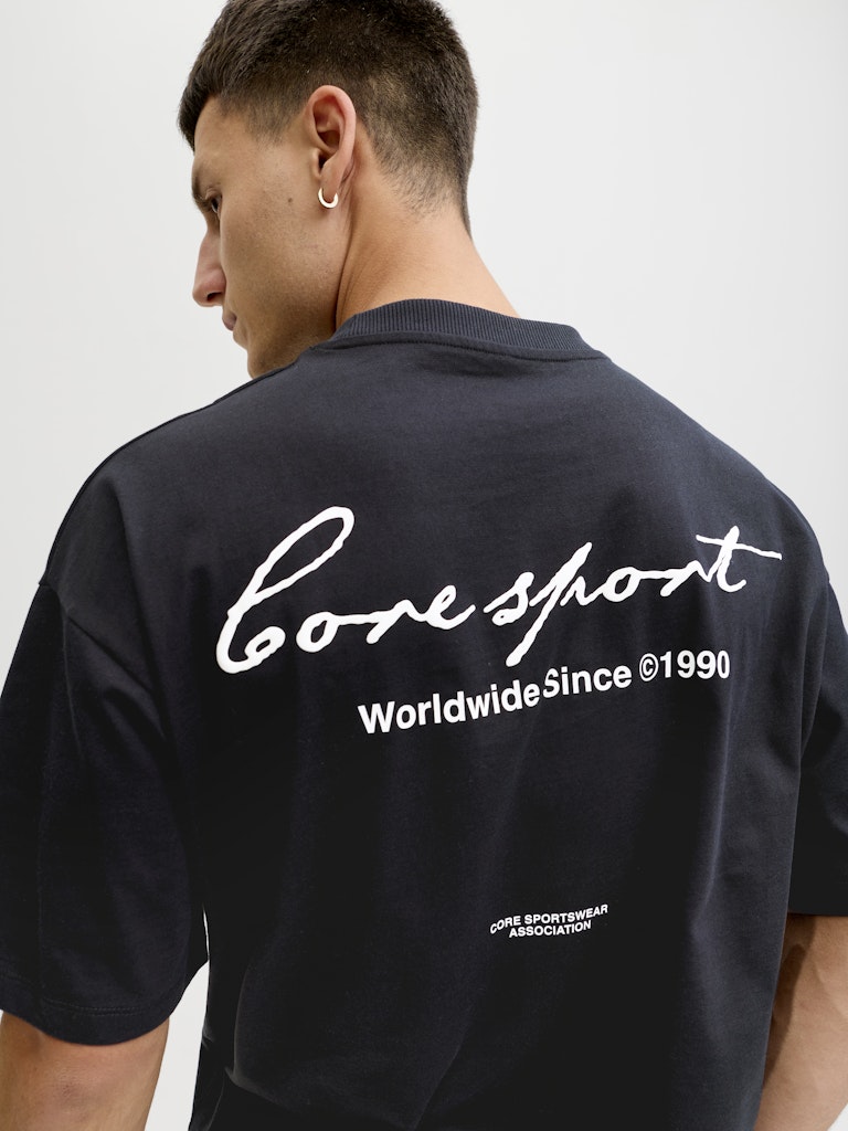 Person wearing a black t-shirt with 'Coresport' branding on the back.