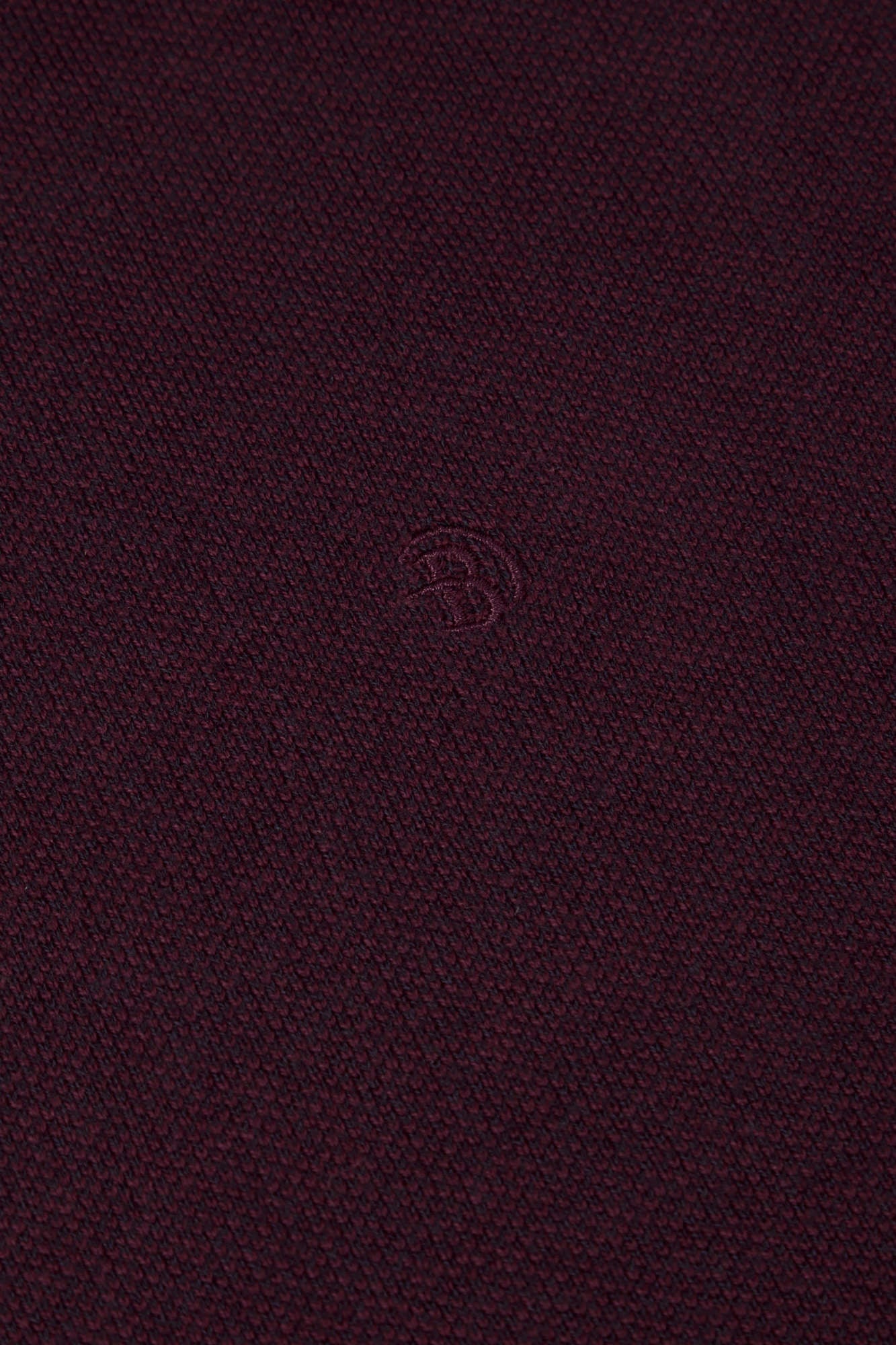 Close-up of Benetti Julius 1/4 Zip Knit in BORDO with textured knit fabric and embroidered logo.