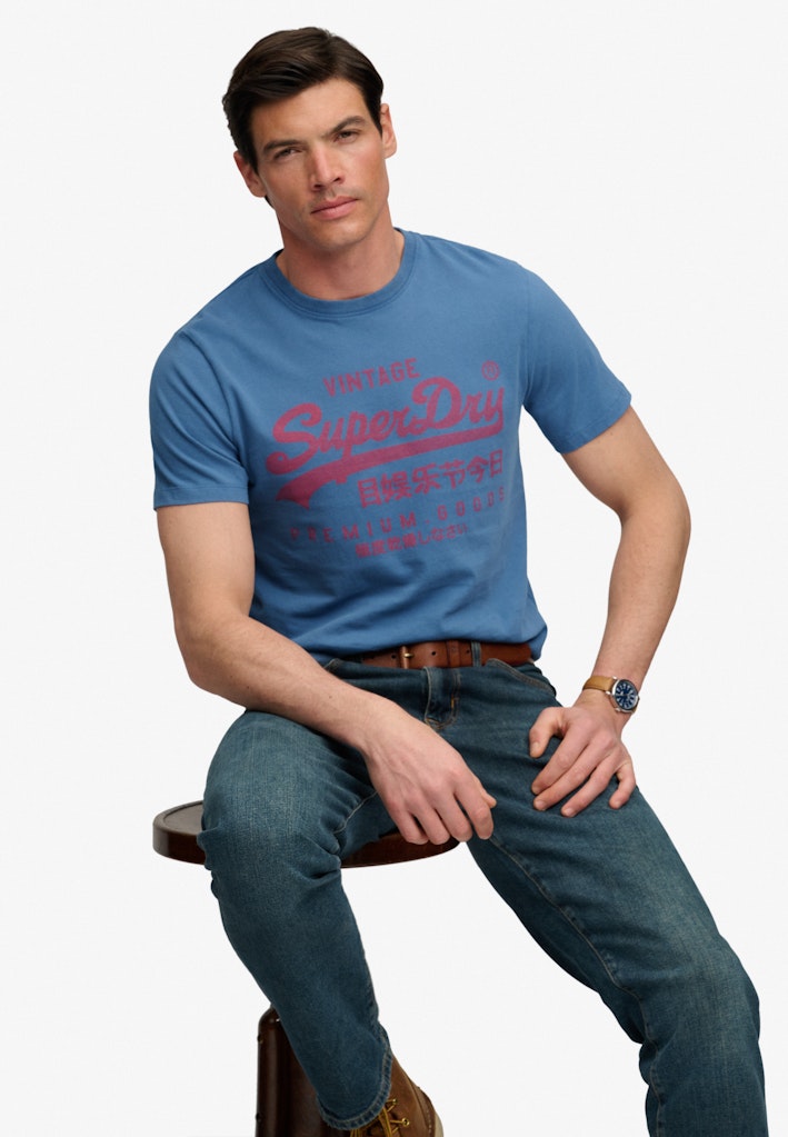 Superdry Vintage Logo Classic Tee in Wedgewood Blue seated model view