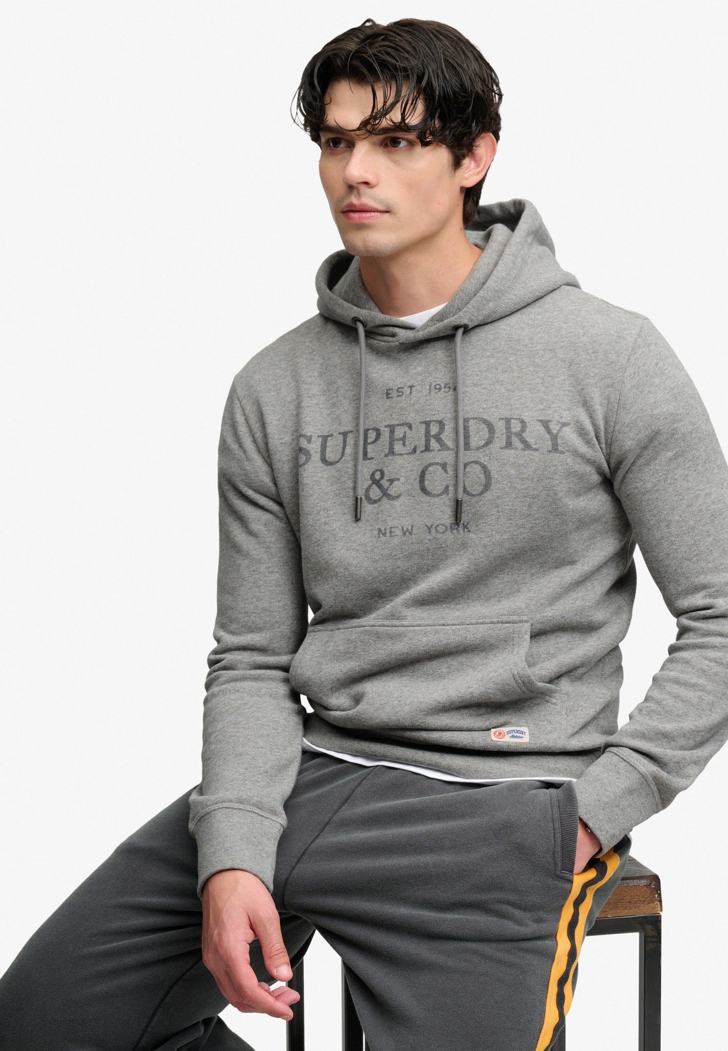 Superdry 1954 Company Relaxed Hood in Dark Vintage Grey Marl seated model view