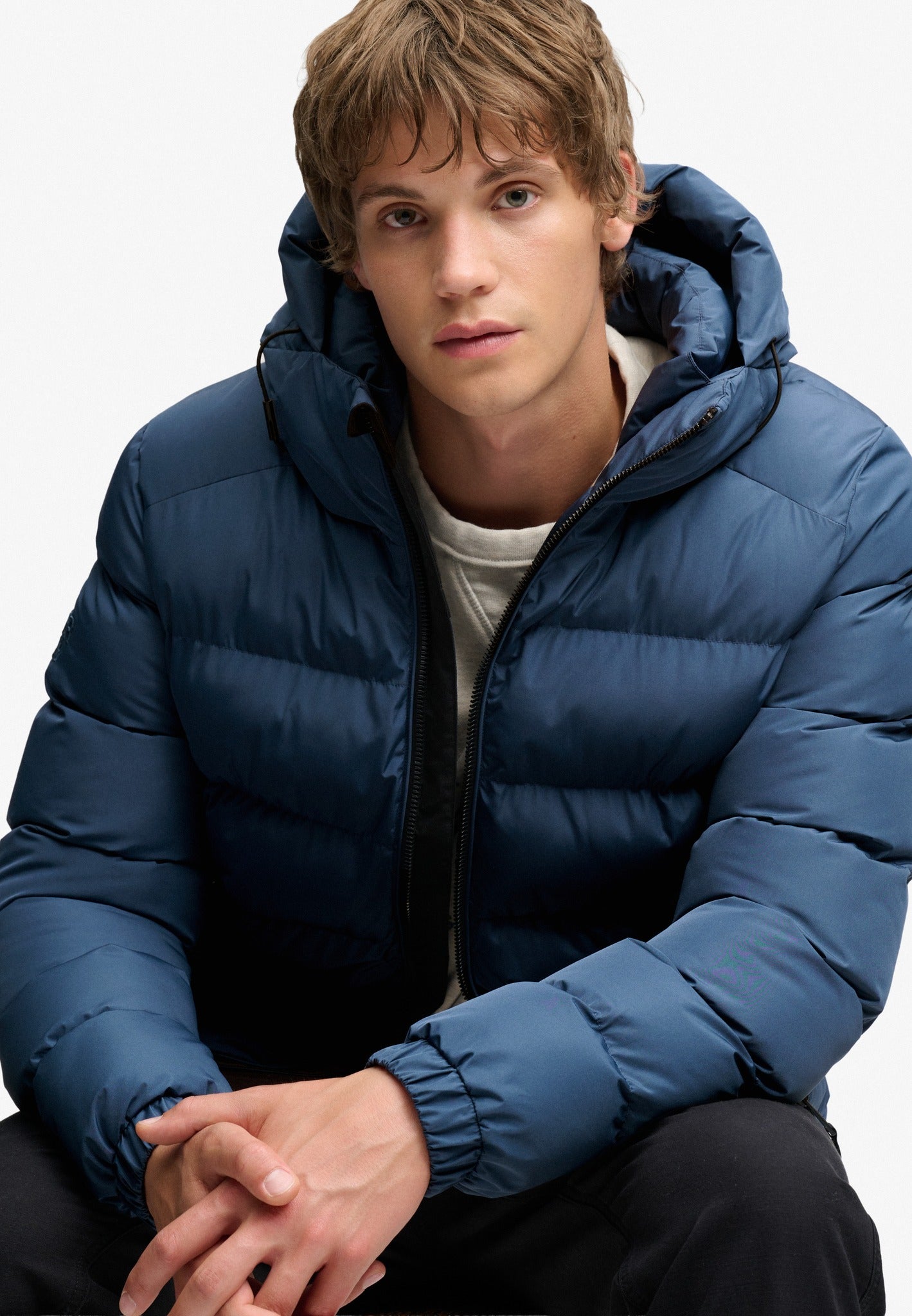 Superdry Hooded Sports Puffer Jacket in Altitude Blue seated model view