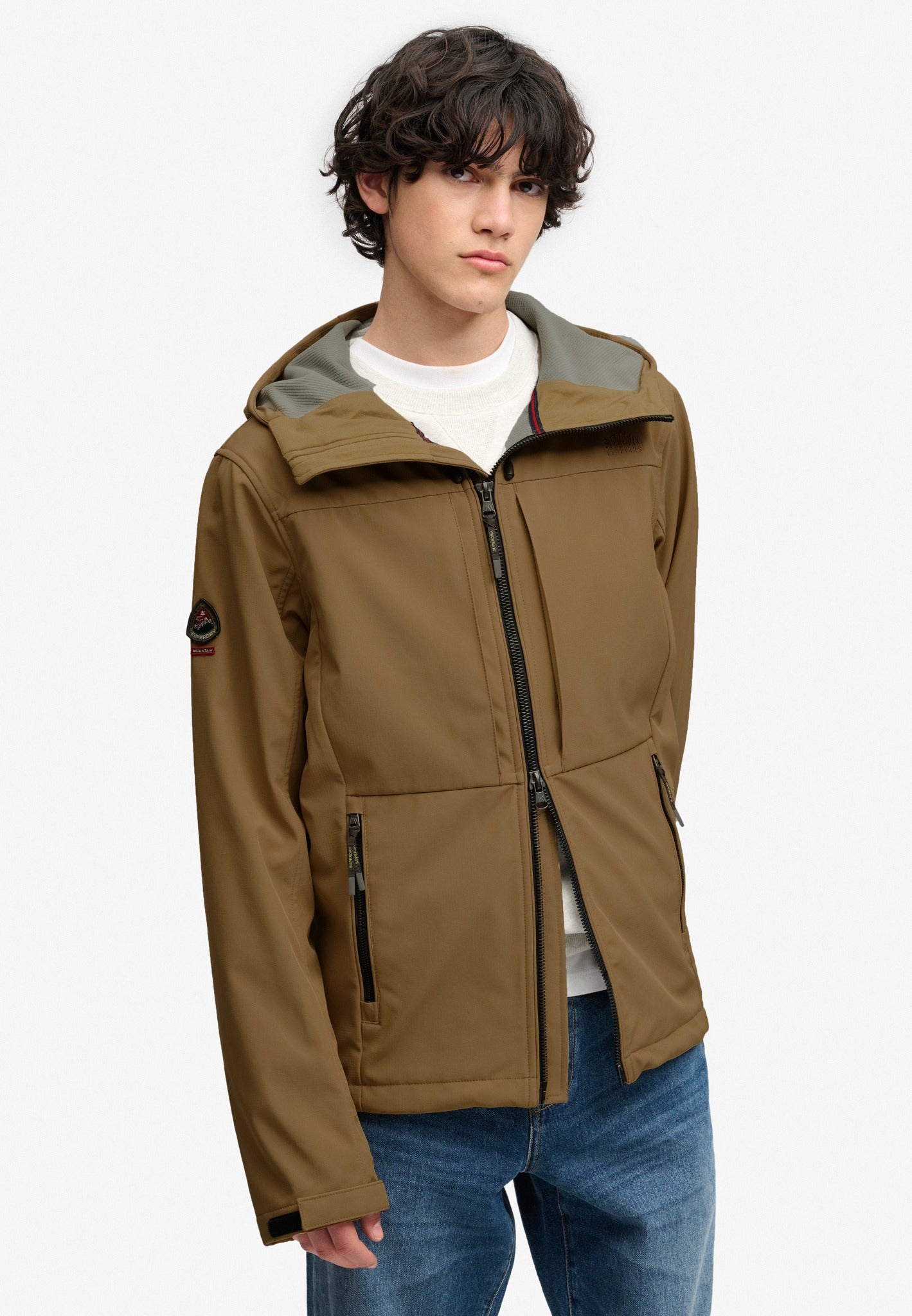 Superdry Hooded Softshell Trekker Jacket in Peak Sands Beige angled view on model