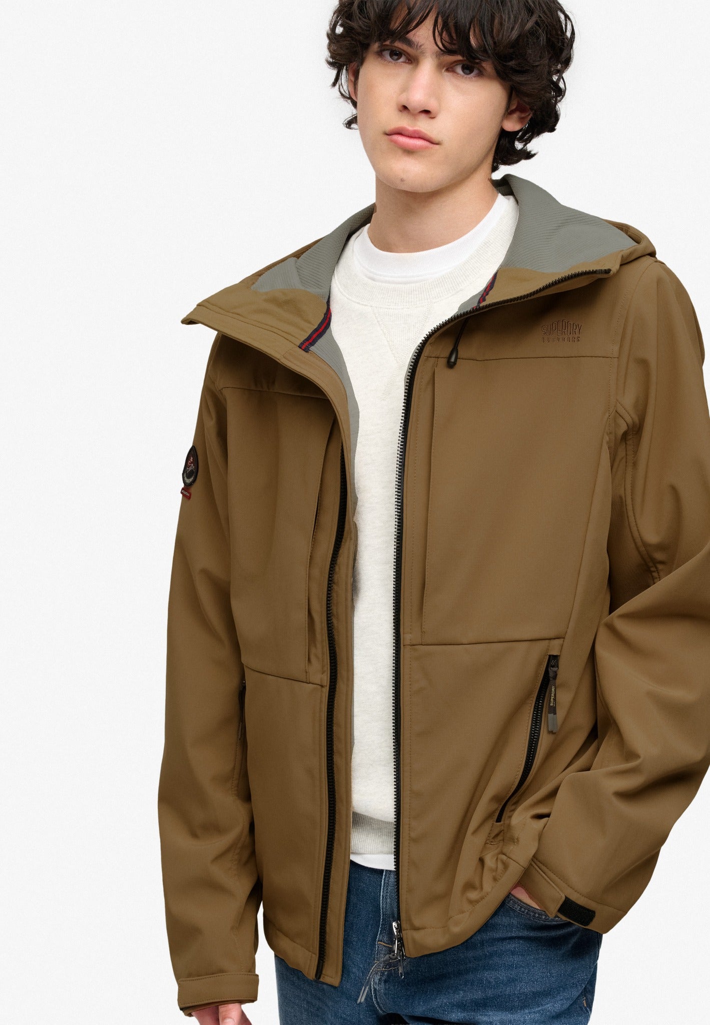 Superdry Hooded Softshell Trekker Jacket in Peak Sands Beige angled view on model angled view