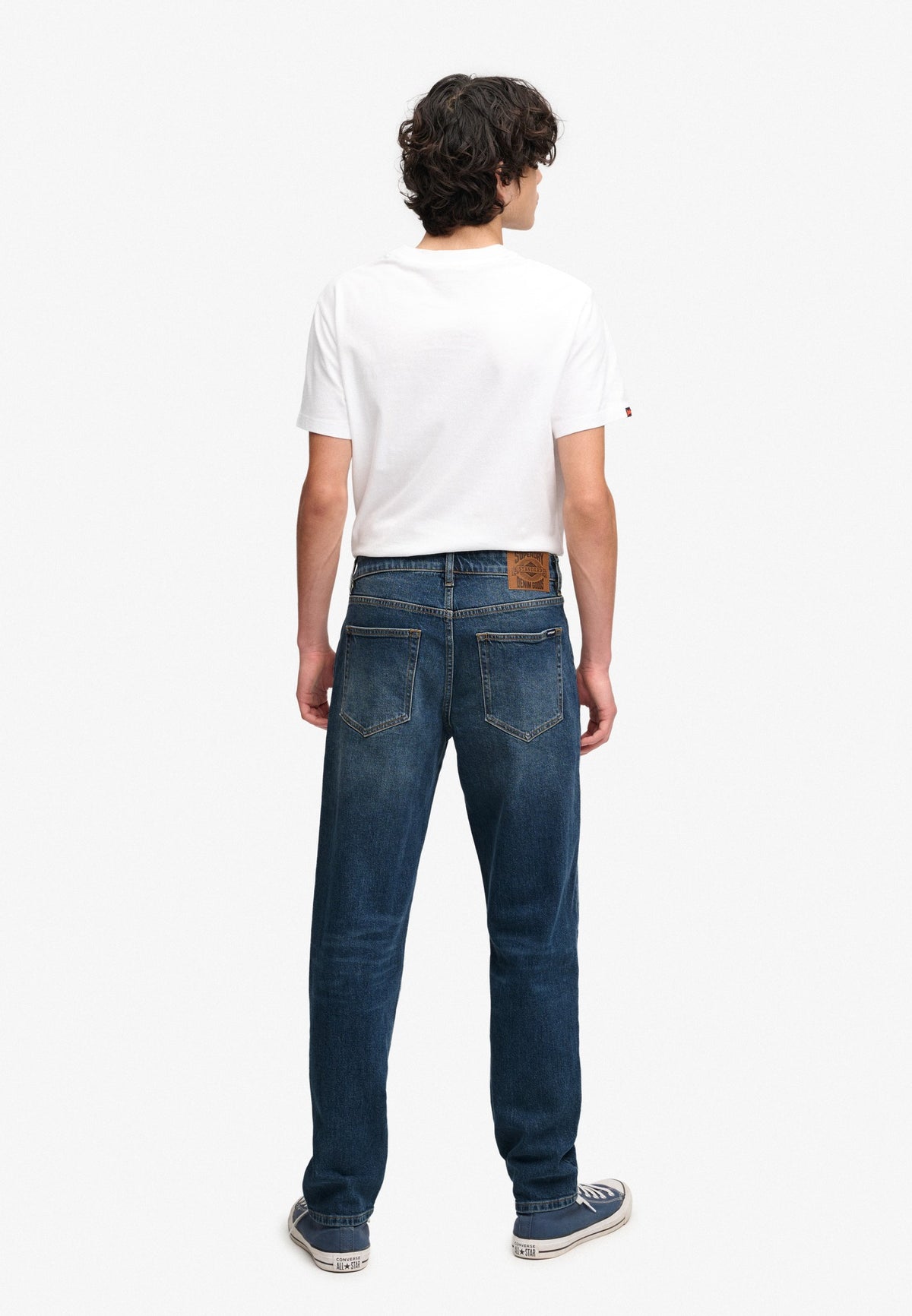 Superdry Vintage Tapered Jeans in Ranch Vintage Indigo angled view on model angled view