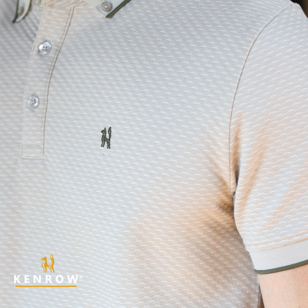 Close-up of a textured beige shirt with a small logo, featuring the brand 'Kenrow'.