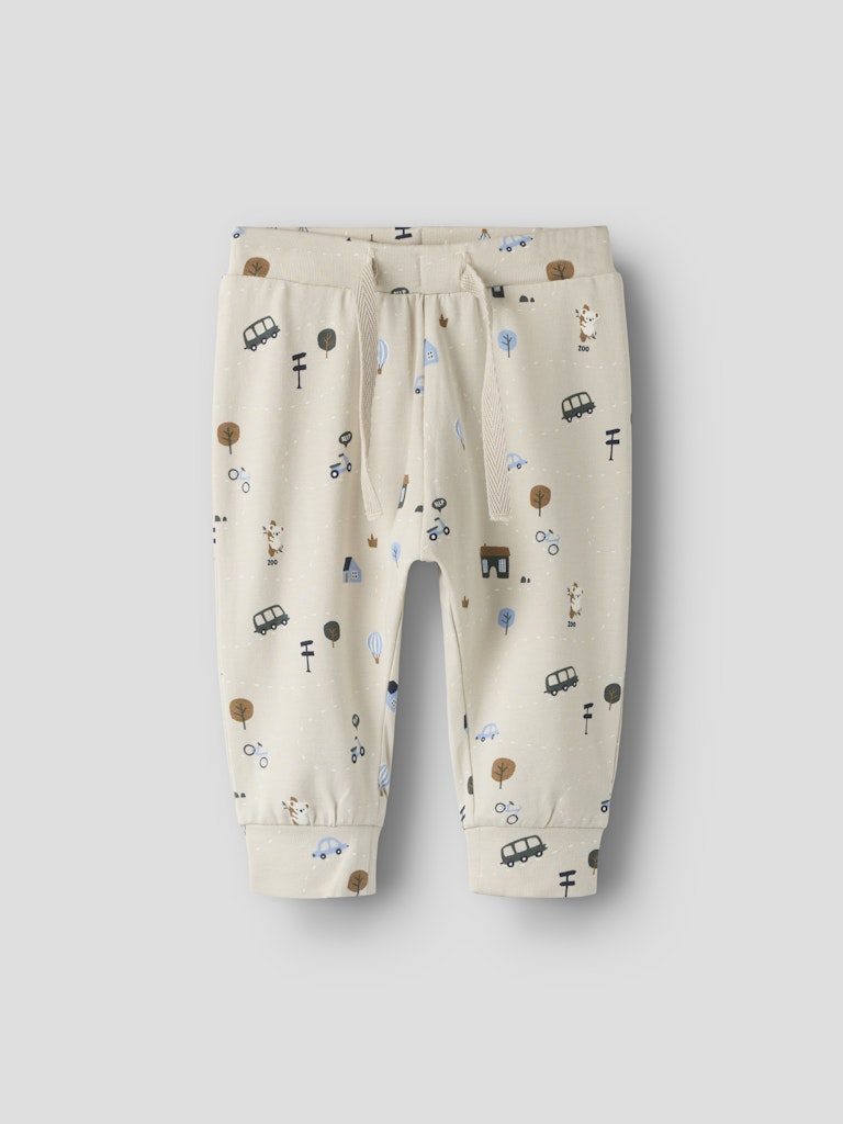 Beige children's pants with vehicle pattern on a light gray background
