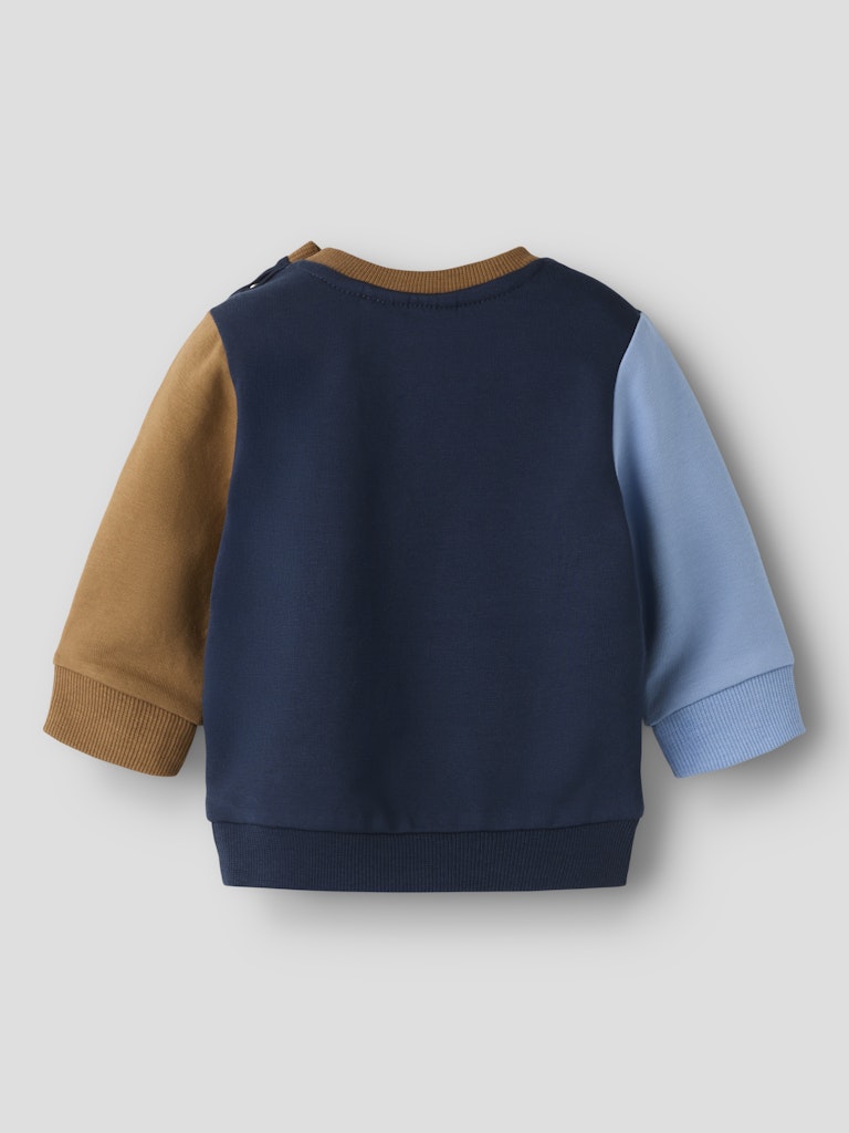 Navy sweater with brown and blue sleeves on a light gray background
