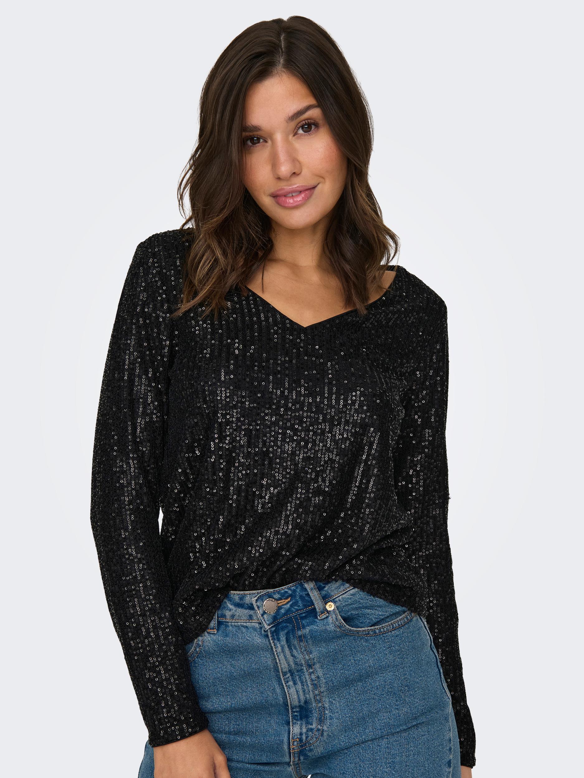 Model wearing the black sequin long sleeve V-neck top from the front