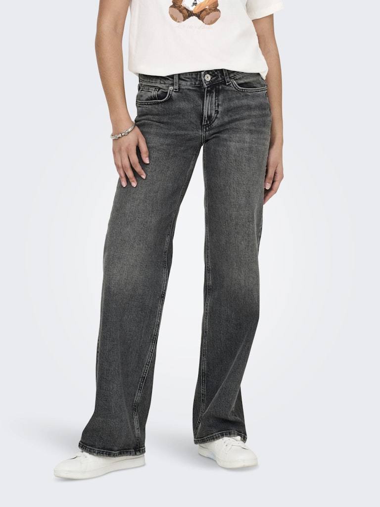 Person wearing black jeans on a white background