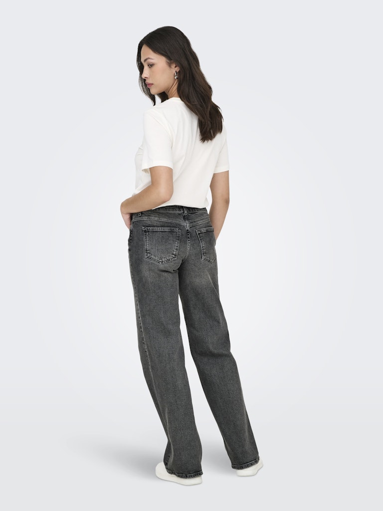 Woman wearing a white top and gray jeans on a white background