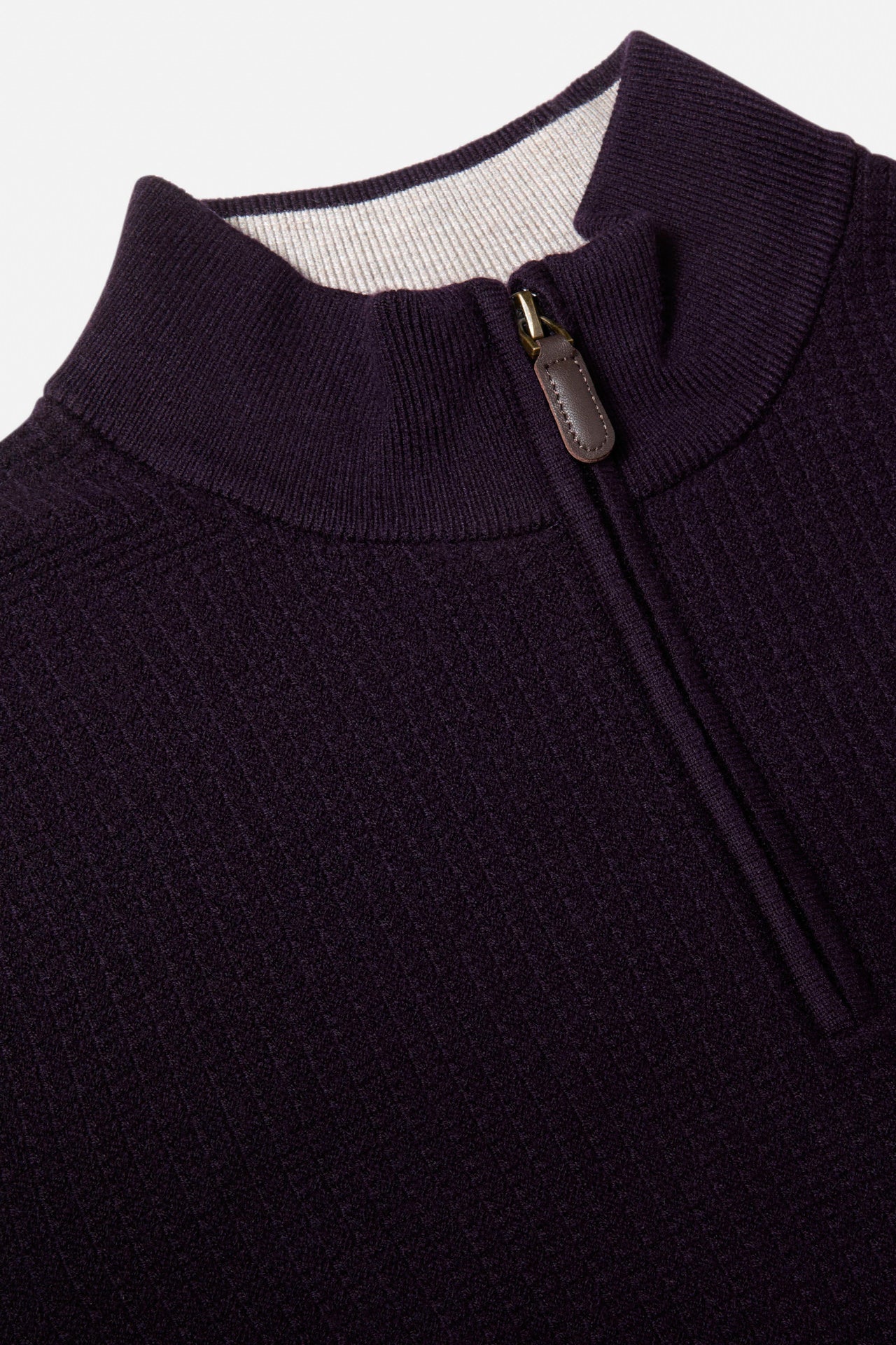 Close-up of a Benetti Oliver Plum 1/4 Zip knit showing the ribbed collar and quarter-zip with leather pull tab.