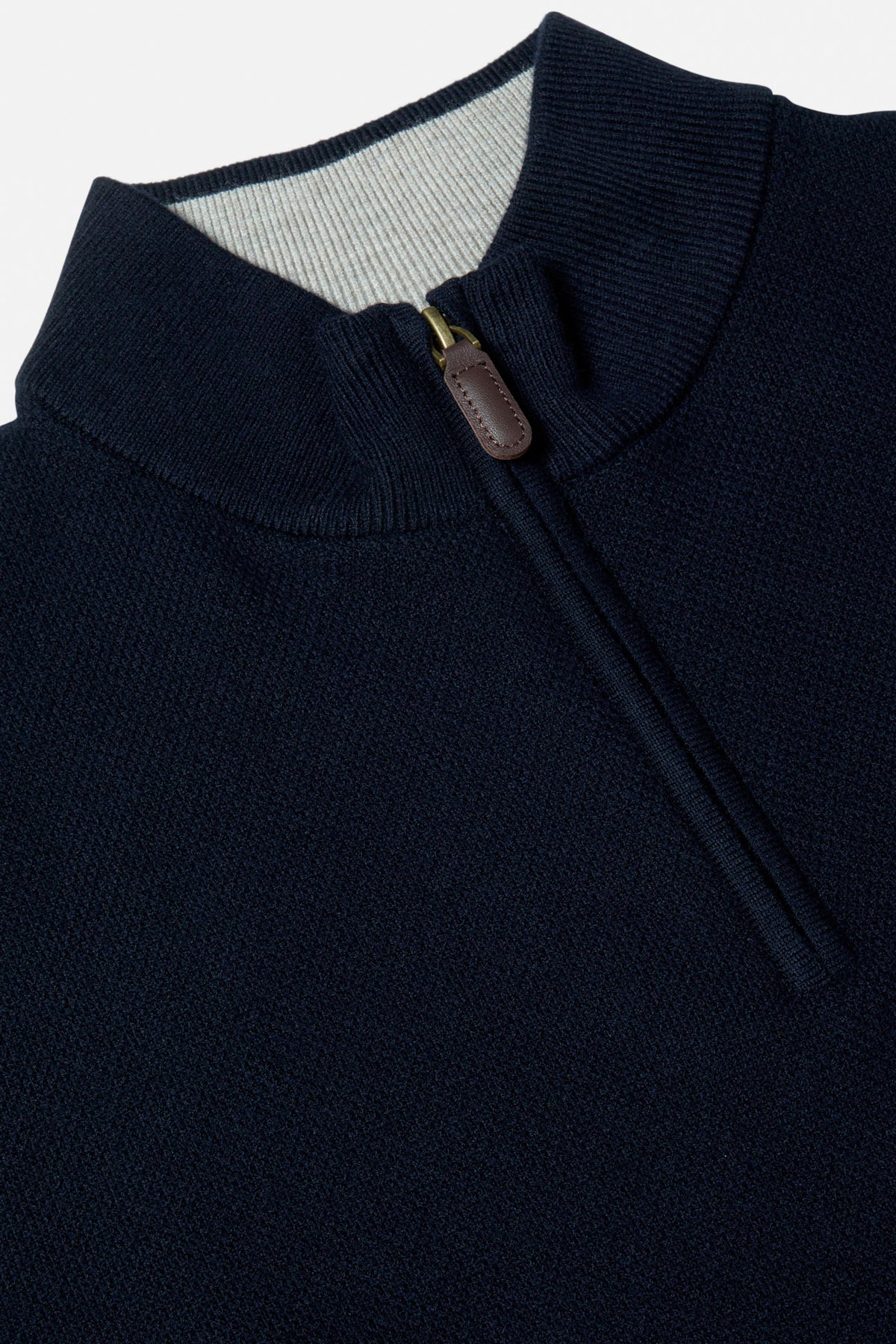 Benetti Quinn Navy 1/4 Zip close-up of the collar and quarter-zip fastening, with ribbed trim and leather pull tab visible.